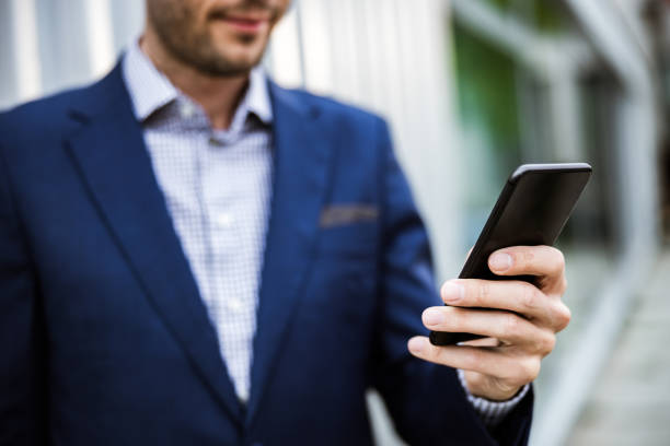 istock Close up of unrecognizable businessman using cell phone. 1182432610