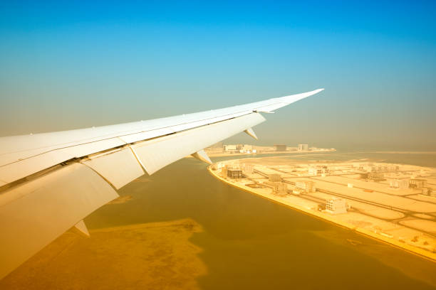 istock Airplane wing on desert city background 1182432843