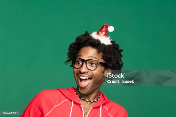 Funny Christmas Portrait Of Excited Young Man Wearing In Red Stock Photo - Download Image Now