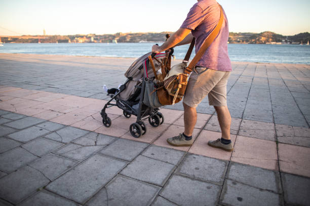 istock Out for a Walk with His Baby Son 1182434298