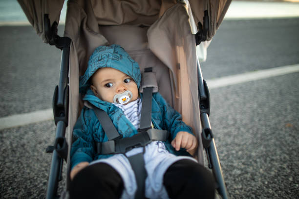 istock Baby boy with pacifier in stroller on sunny day 1182434782