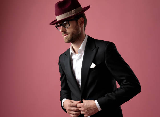 istock Hopeful elegant man looking away and unbuttoning his jacket 1182434863