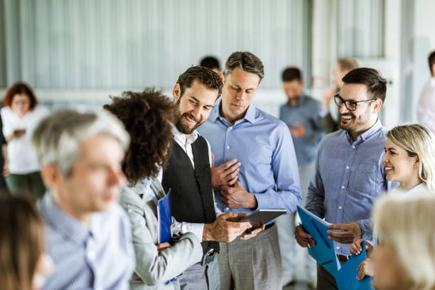 istock Team of business colleagues talking while using digital tablet in the office. 1182435195