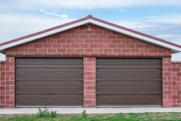 istock Brick garage with roller shutters for two cars 1182435834