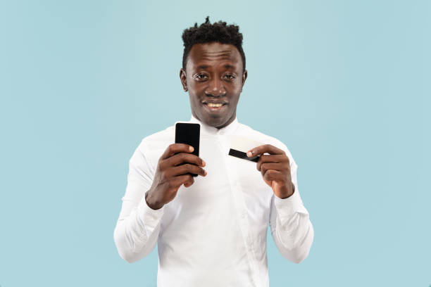 istock Young african-american man isolated on blue studio background, human emotions concept. 1182435931