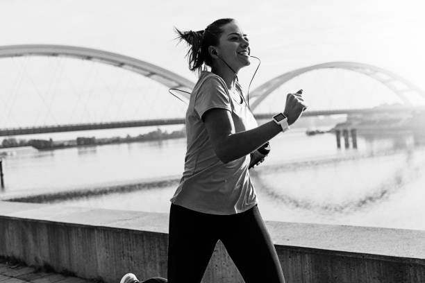 istock Young woman running ,black and white 1182436465