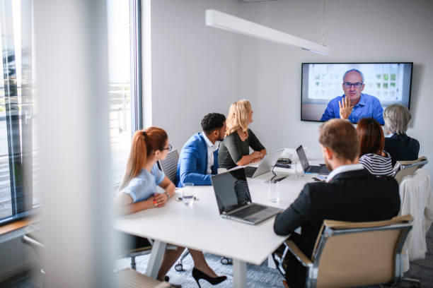 istock Male and Female Executive Team Video Conferencing with CEO 1182436559