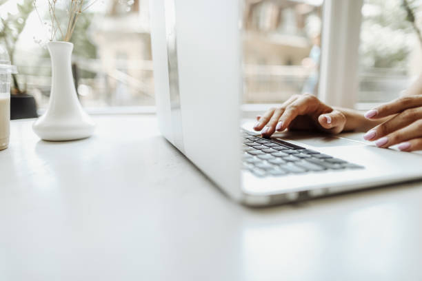 istock Hands typing on laptop keyabord on white table with copyspace 1182436561
