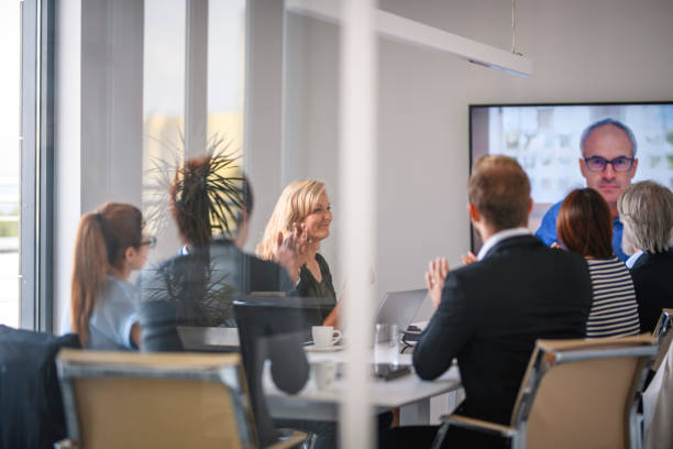 istock Smiling Executive Team Celebrating Good News from CEO 1182436564