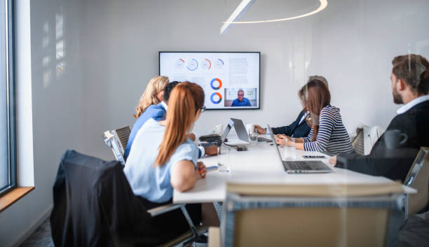 istock CEO Video Conferencing with Executive Team in Board Room 1182436569
