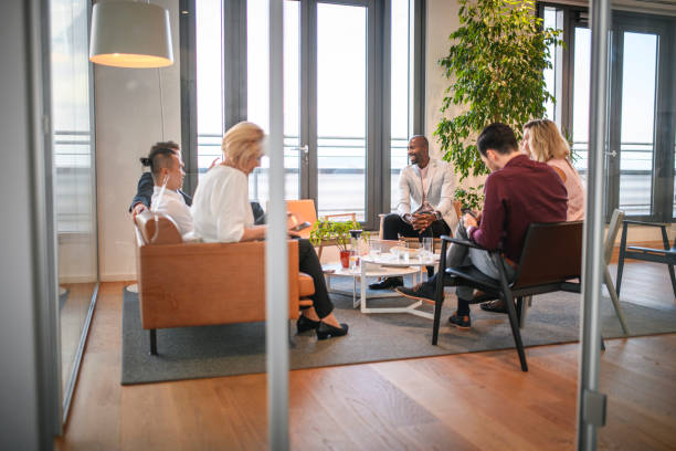 istock Business People Relaxing in Lobby During Seminar Break 1182436593