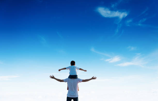 istock Father carrying his son on shoulders 1182436879