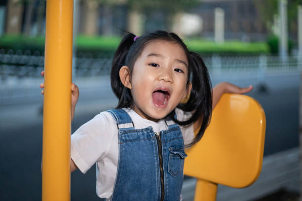 istock Cute Girl Playing seesaw 1182436883