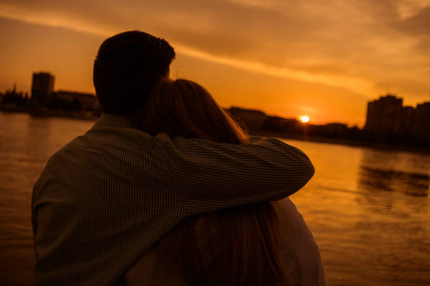 istock Young couple in sunset 1182437909