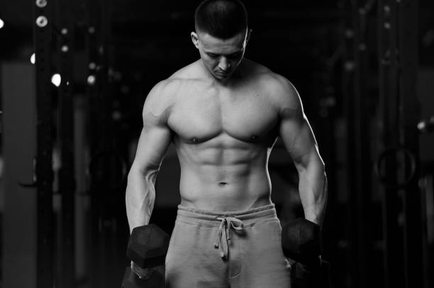 istock Shirtless Athletic Young Man With Dumbbells 1182437984