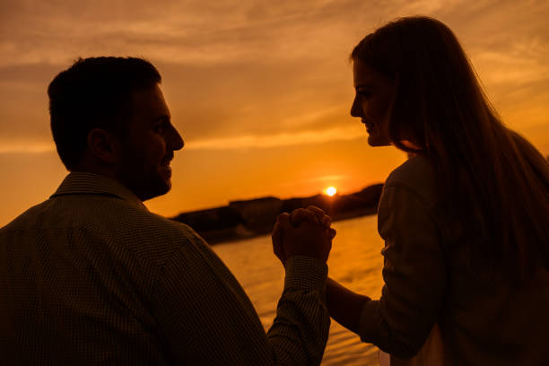 istock Young couple in sunset 1182438118