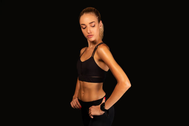 istock Sporty Girl Posing Over Black Background, Studio Shot 1182438224