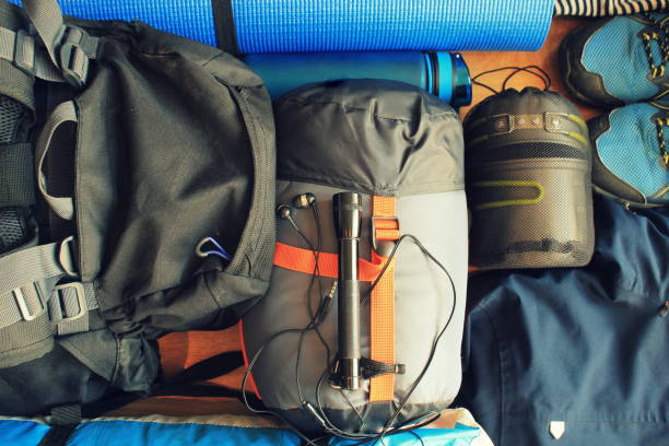 Flat lay composition with camping equipment on wooden background