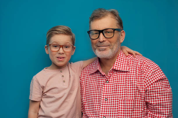 istock Young boy hugs grandpa smiling at the camera 1182439521