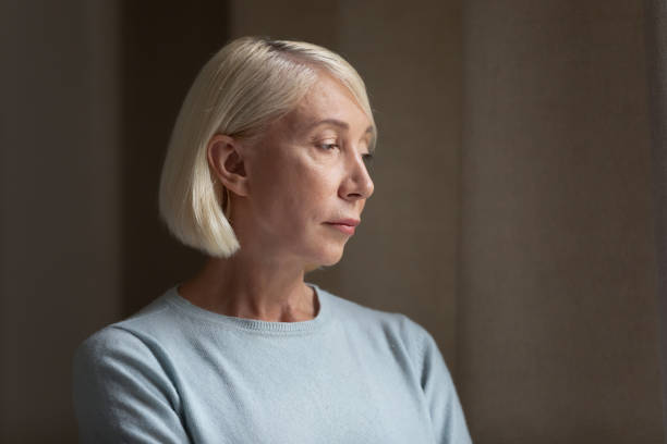 istock Upset mature lost in thoughts lady feeling lonely. 1182440323