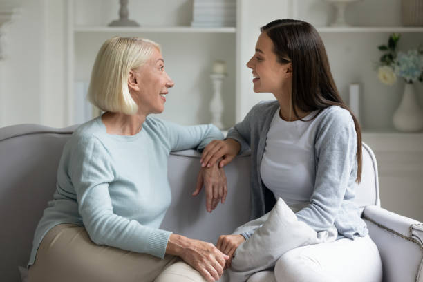 istock Happy elderly lady communicating with grown up attractive daughter. 1182440348