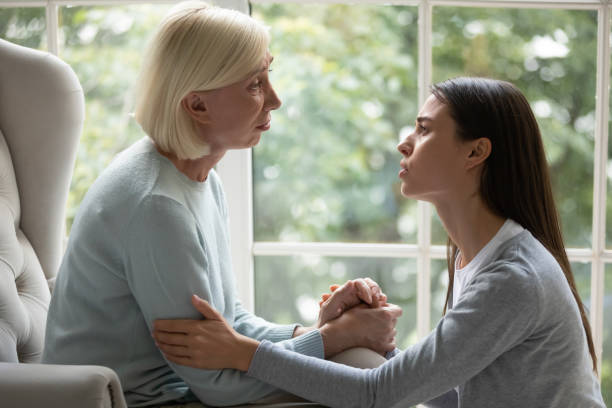 istock Upset empathic young lady showing support to mother. 1182440378
