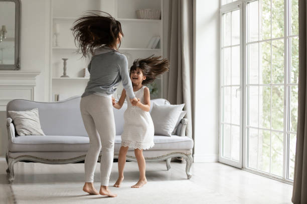 istock Overjoyed young mommy jumping together with cute daughter. 1182440384