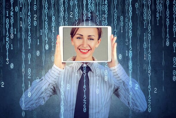 Happy woman holding tablet with her face displayed on a screen Happy woman holding tablet with her face displayed on a screen isolated on binary code background synthetic identity theft stock pictures, royalty-free photos & images
