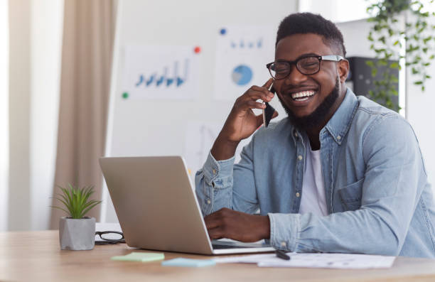 istock Cheerful Entrepreneur Speaking On Mobile Phone While Working In Office 1182441254