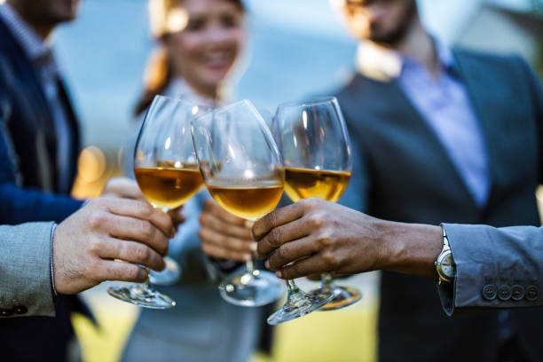 close up of business team toasting with wine outdoors. - party business toast champagne imagens e fotografias de stock