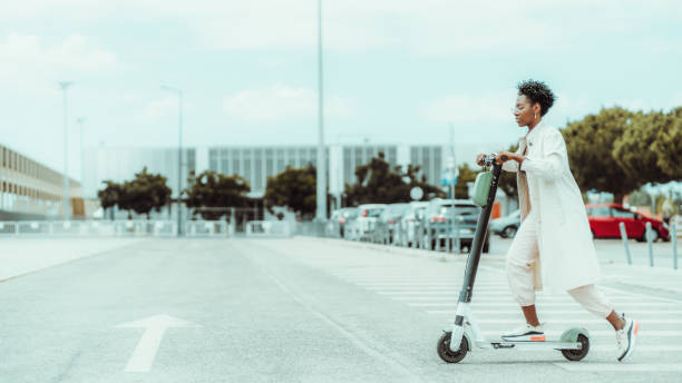 istock Black girl on e-scooter outdoors 1182441500