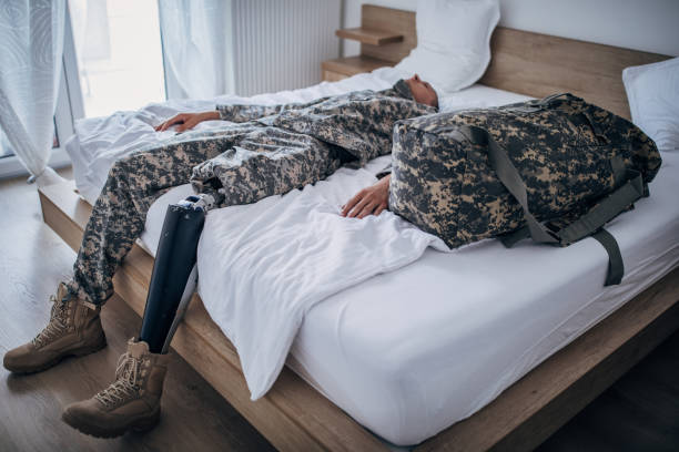 istock Disabled veteran soldier lying alone in bedroom 1182441892