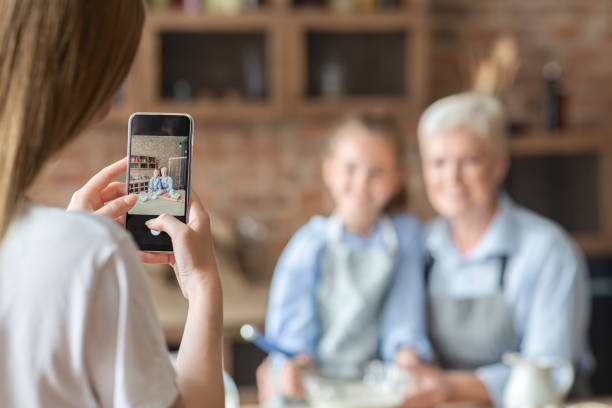 istock Woman taking photo on smartphone in kitchen 1182445721