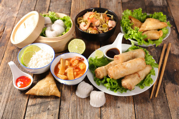istock assorted of asian food, spring roll, samossa, rice, soup, shrimp 1182445992