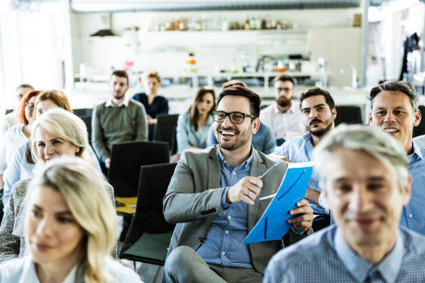 istock Happy businessman talking about reports on a seminar in board room. 1182446130