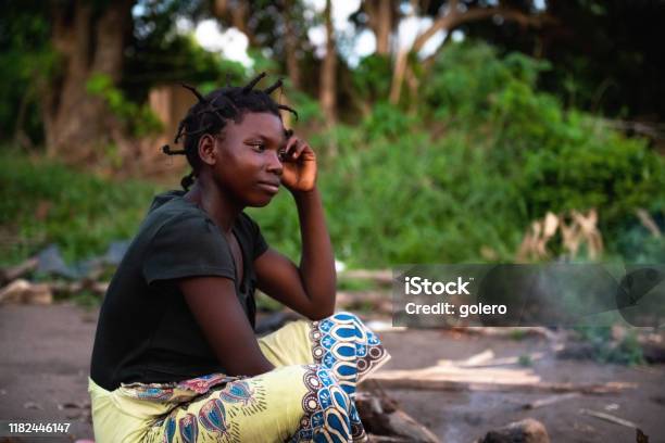 Portait Of Young African Woman Sitting On The Ground Stock Photo - Download Image Now