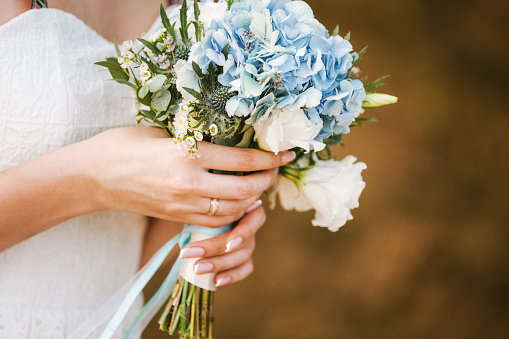 beautiful wedding bouquet of flowers in bride's hands. copy space