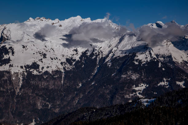 istock Panorama of winter Alps with low clouds 1182447704