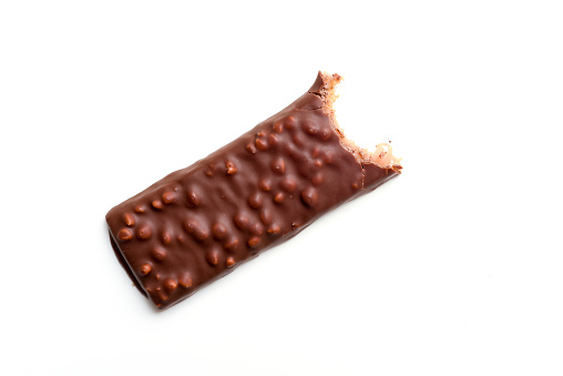 Tasty chocolate bar with a bite taken out isolated High calorie snack food