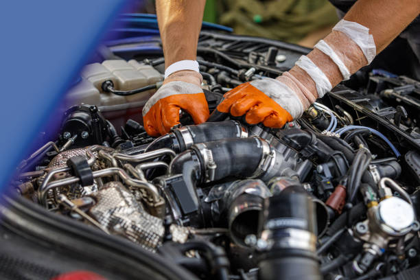 istock Automobile mechanic repairing a car engine. 1182450922