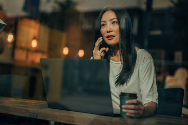 istock Young woman working on laptop in cafe 1182452164