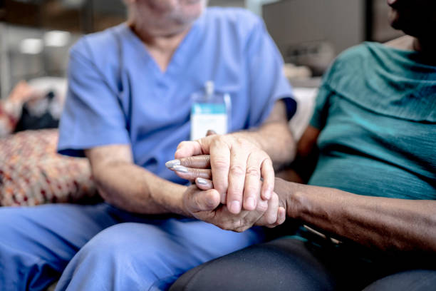 Nurse holding patient's hands
