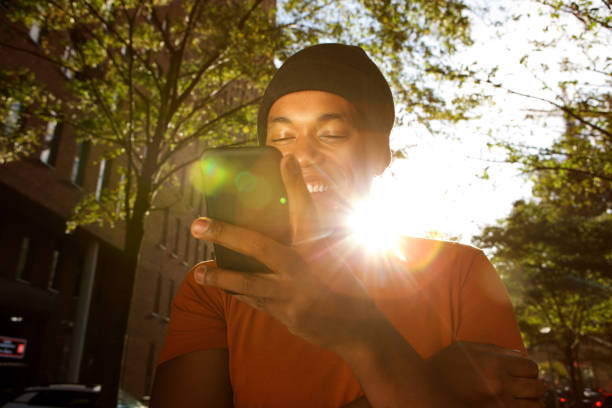 istock Close up young black man looking at mobile phone on sunny day 1182452411