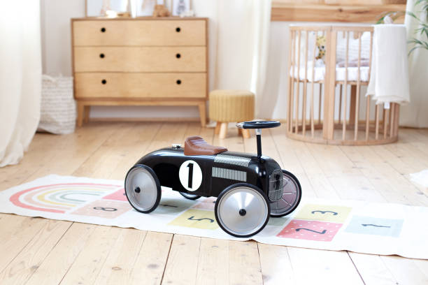 chalet baby schlafzimmer interior mit gemütlichen wiege bett. hellbraunes kinderzimmer mit holzbett. gemütliche haus hygge stil design. eco-haus. retro kinder rennwagen. rustikalen. kindergarten. skandinavischen - spielzimmer fotos stock-fotos und bilder