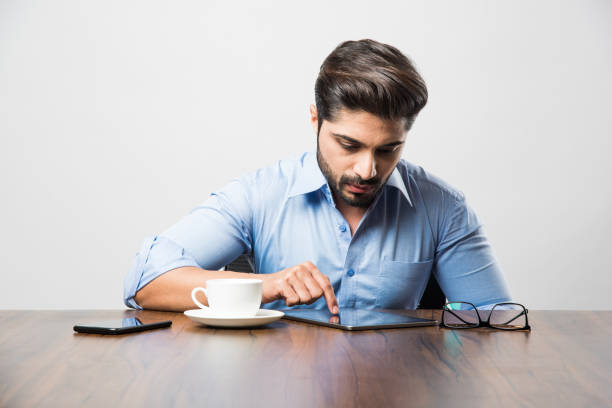 istock Indian business man using cell phone. Having Conversation or typing or checking social media feeds 1182452709