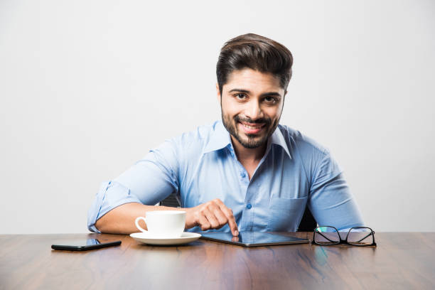 istock Indian business man using cell phone. Having Conversation or typing or checking social media feeds 1182453006