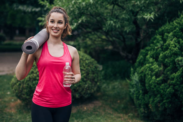 istock Beautiful woman going training in park 1182453231