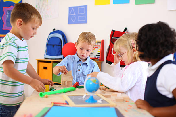 istock Kids playing inside a preschool classroom 118245339