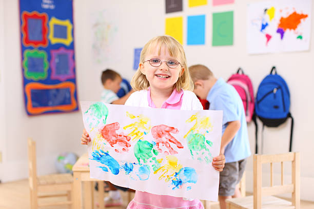 istock Preschool girl holding up artwork 118245367