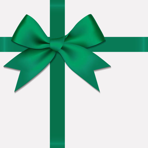 istock Realistic decorative shiny satin green ribbon bow, isolated on white background 1182454686